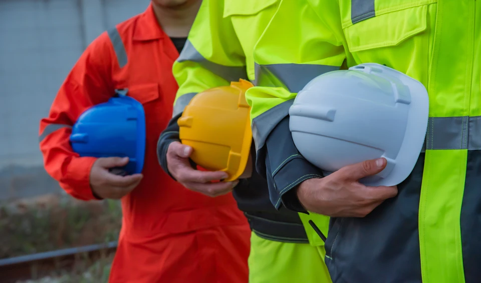 Diagnostiqueur immobilier inspectant l'intérieur d'un logement, examinant les cloisons et la structure d'un mur, tenant une tablette numérique à la main pour relever les données techniques du bâtiment, concentré sur son travail de diagnostic de performance énergétique.